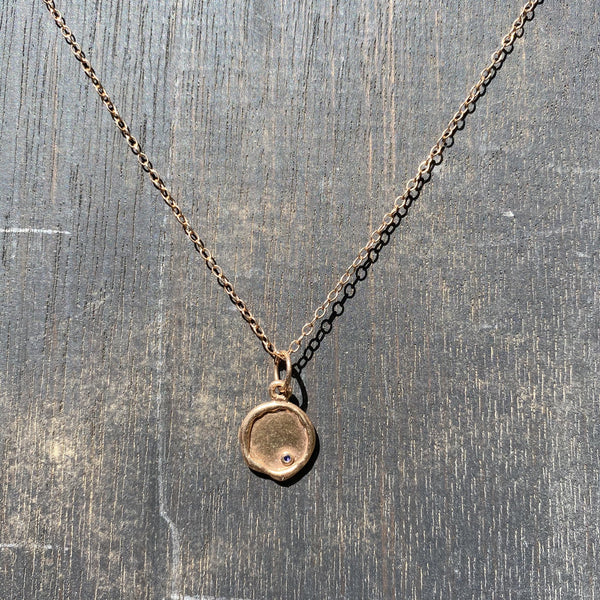 14k rose gold medallion with blue sapphire